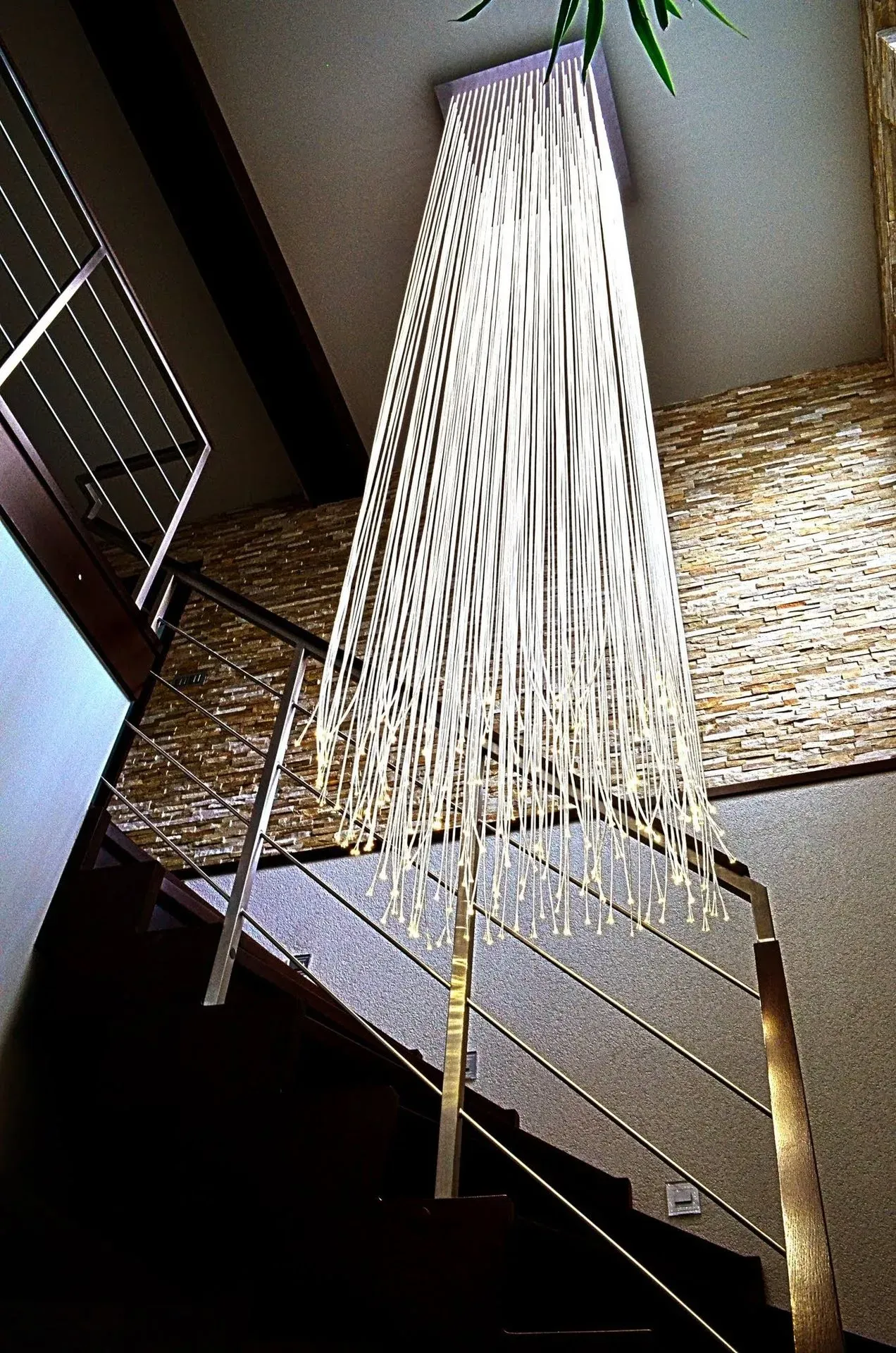 Luxury modern fibre optic chandelier in private house on staircase