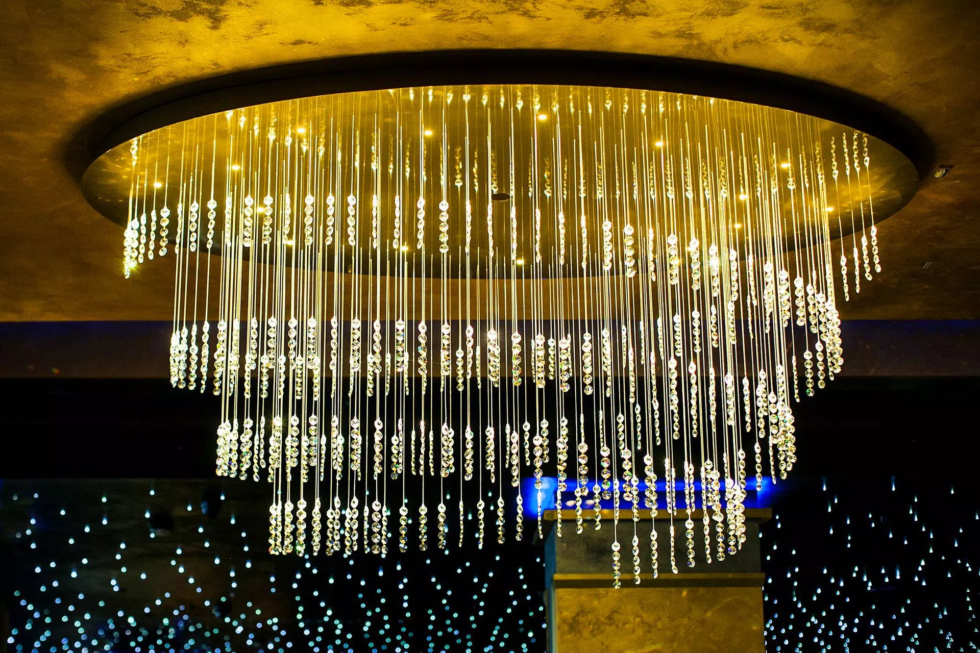 Detail of unique modern chandelier TWIRL by FOSALI is made of fibre optic system and crystals for decorative lighting casino