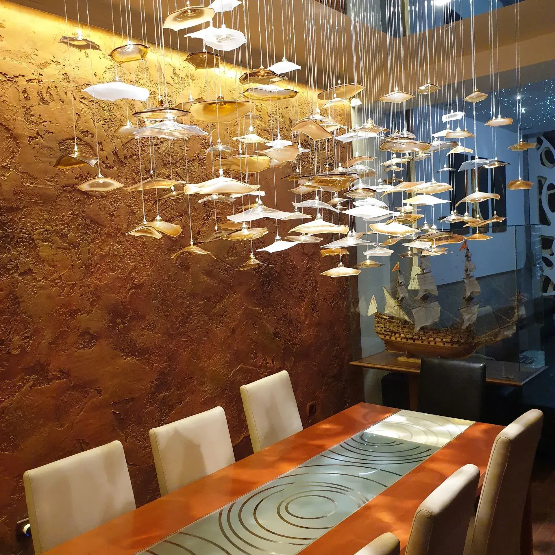 Infinito gold white glass chandelier in Showroom