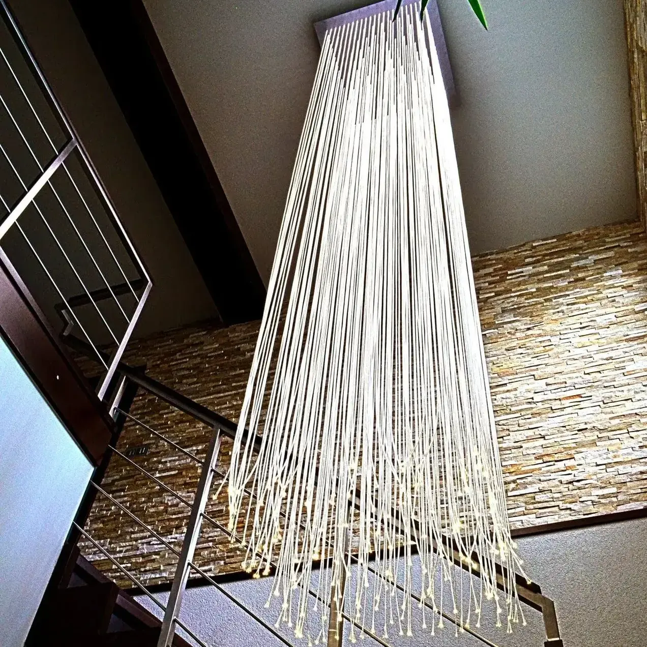 Luxury modern fibre optic chandelier in private house on staircase