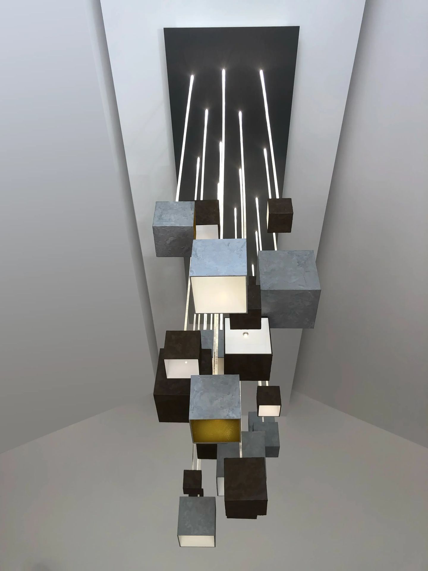 GRAIN chandelier attached to ceiling in angled sloped rooftop
