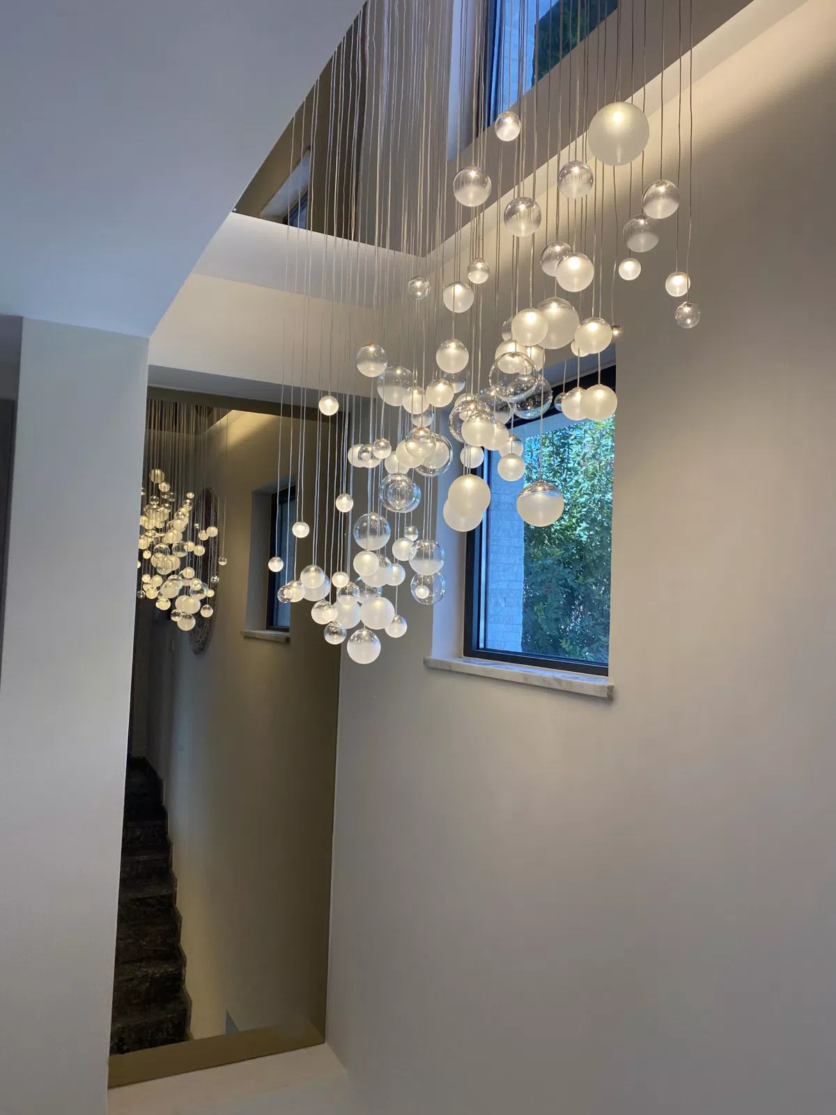 LED glass ball lighting LURE chandelier above staircase
