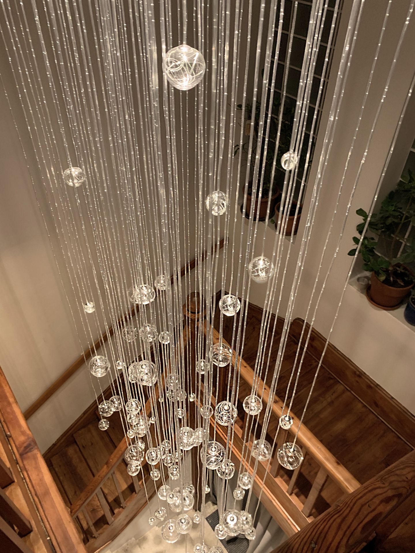 Top detail view on AQUILA fibre optic chandelier installed at staircase