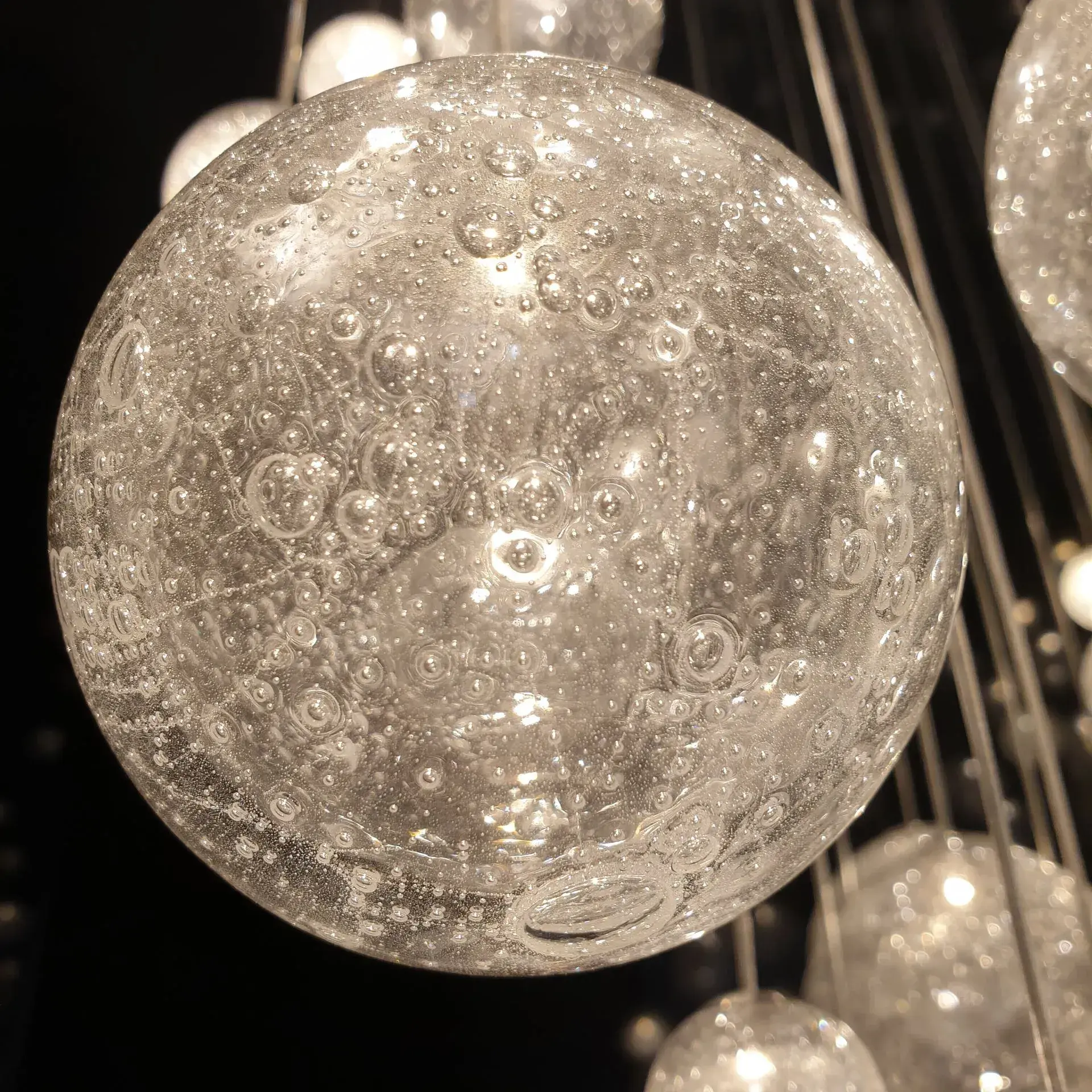 ELUDA modern design chandelier made of glass and LED modules for livingroom, bedroom, hotel large interior spaces. Glass ball detail