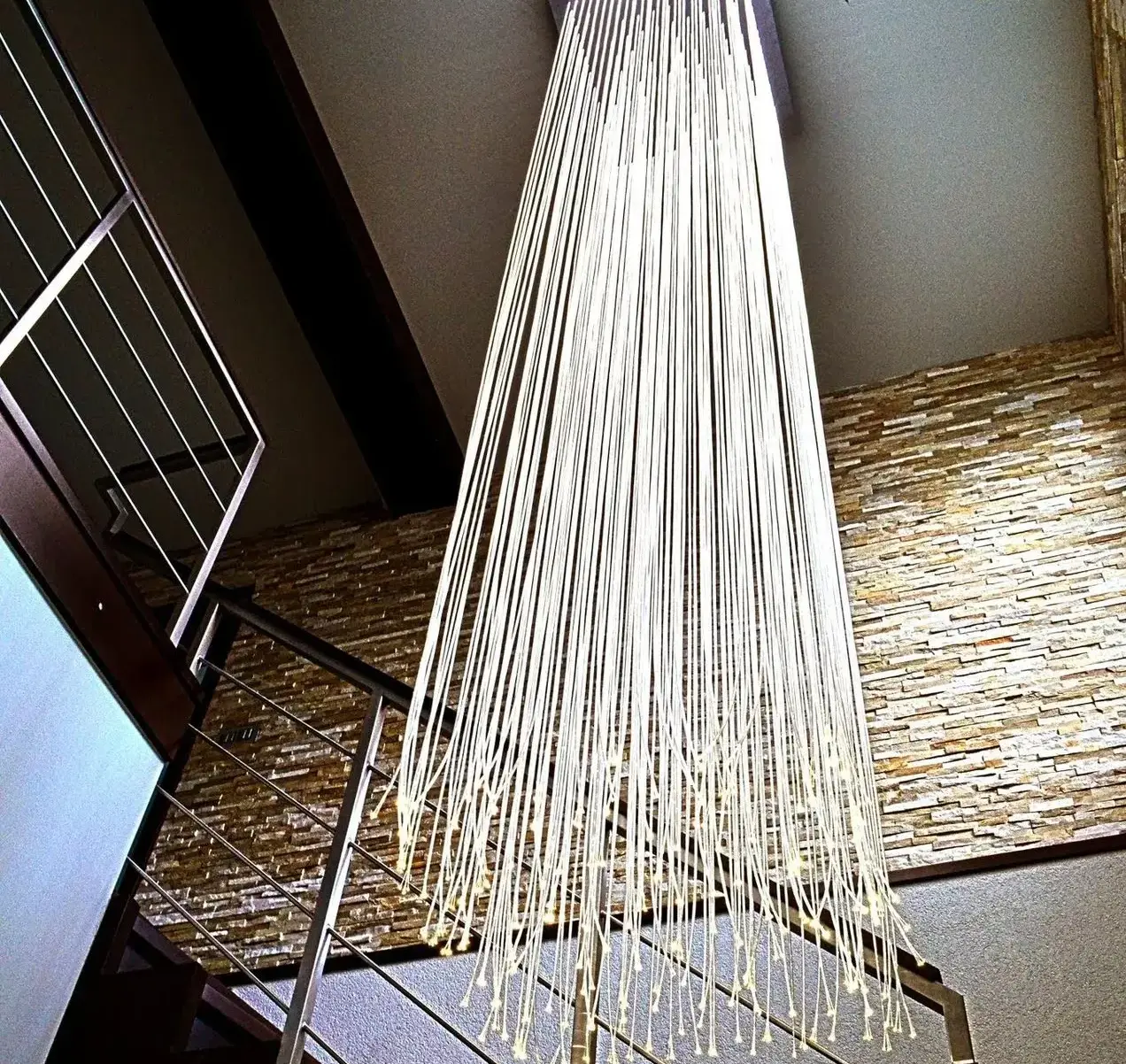 Luxury modern fibre optic chandelier in private house on staircase